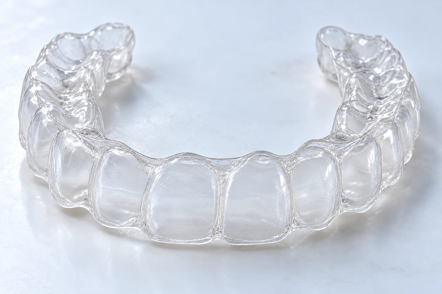 The same aligner clean and clear after the routine; illustrative