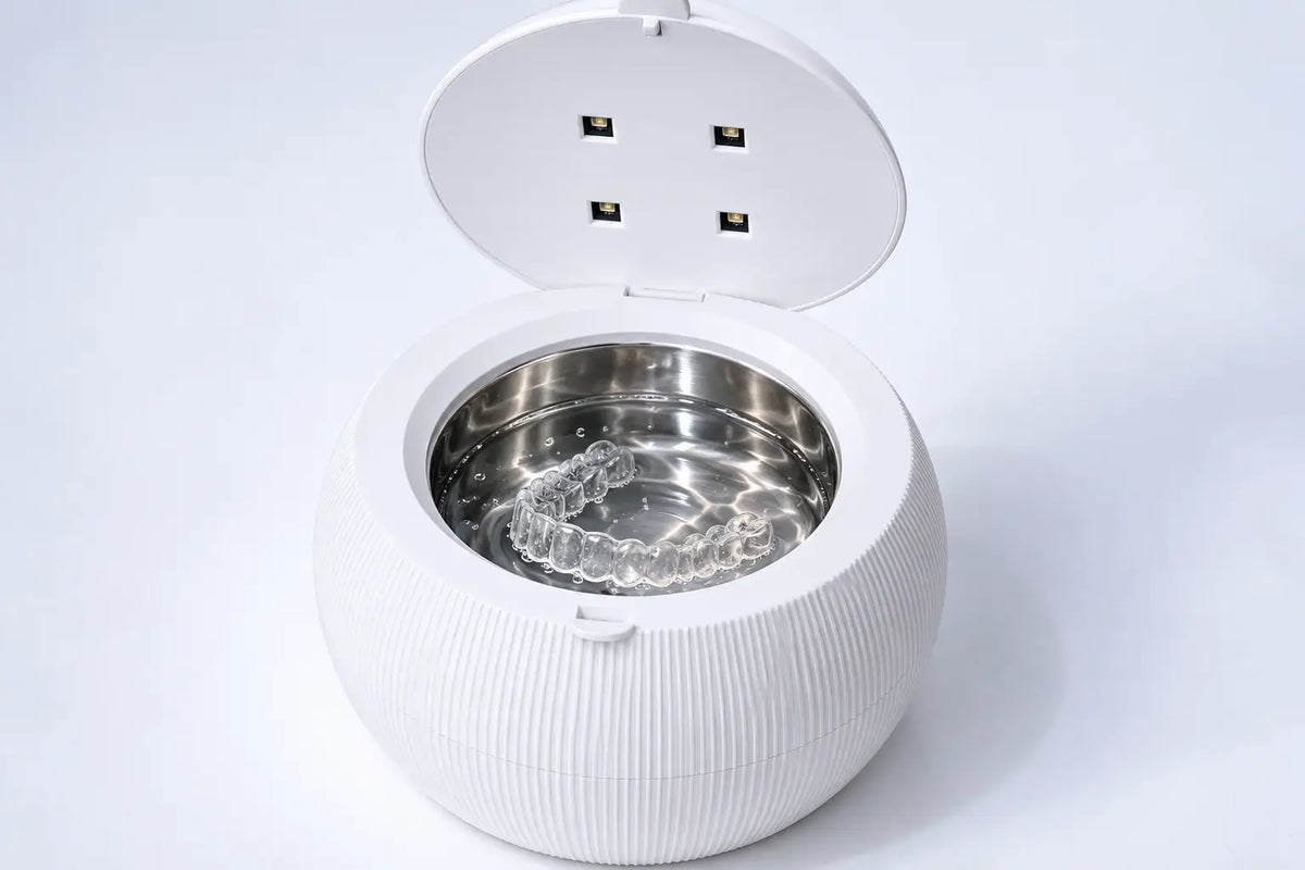 A clear aligner inside the ShinePod tank; illustrative